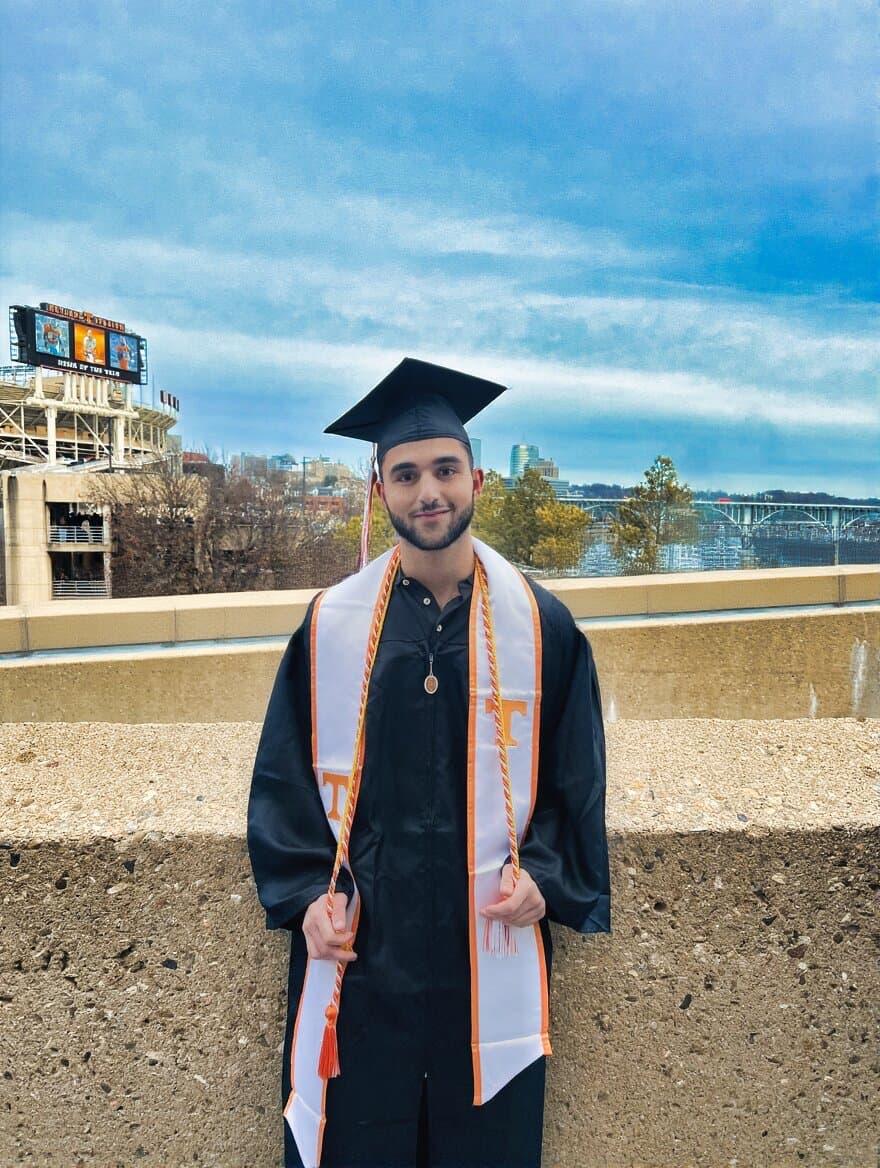 Graduation day — cap, gown, and the river behind